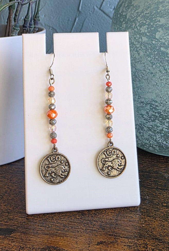 Pair of beaded earrings with Leo Zodiac pendant