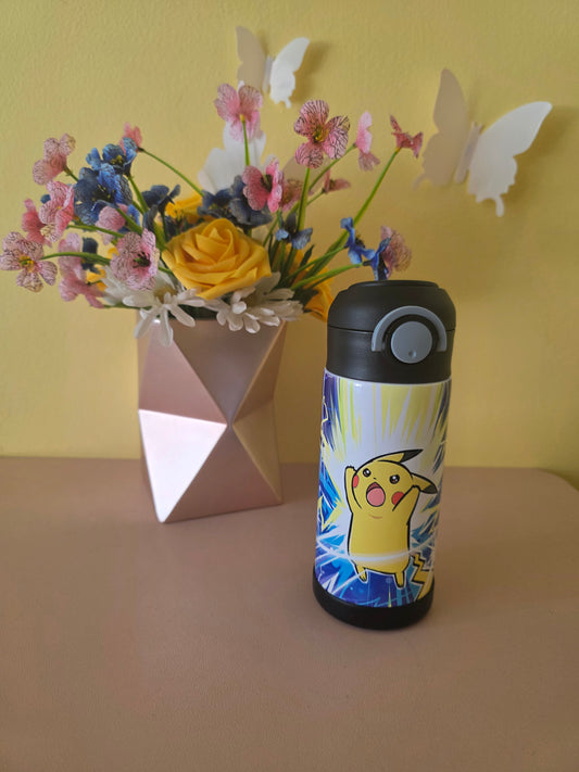 Pokemon Pikachu water bottle on a table with flowers in the background