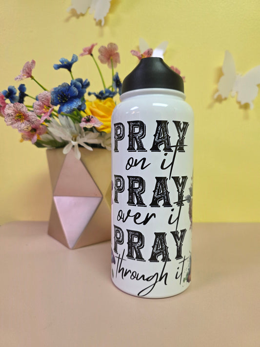Water bottle with 'PRAY' text on a yellow background with flowers