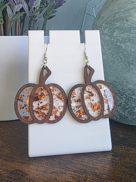 Pair of earrings on a white card with a natural background