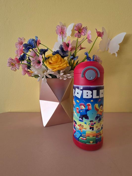Roblox Stainless Steel Tumbler for kids on a table with flowers in the background. 