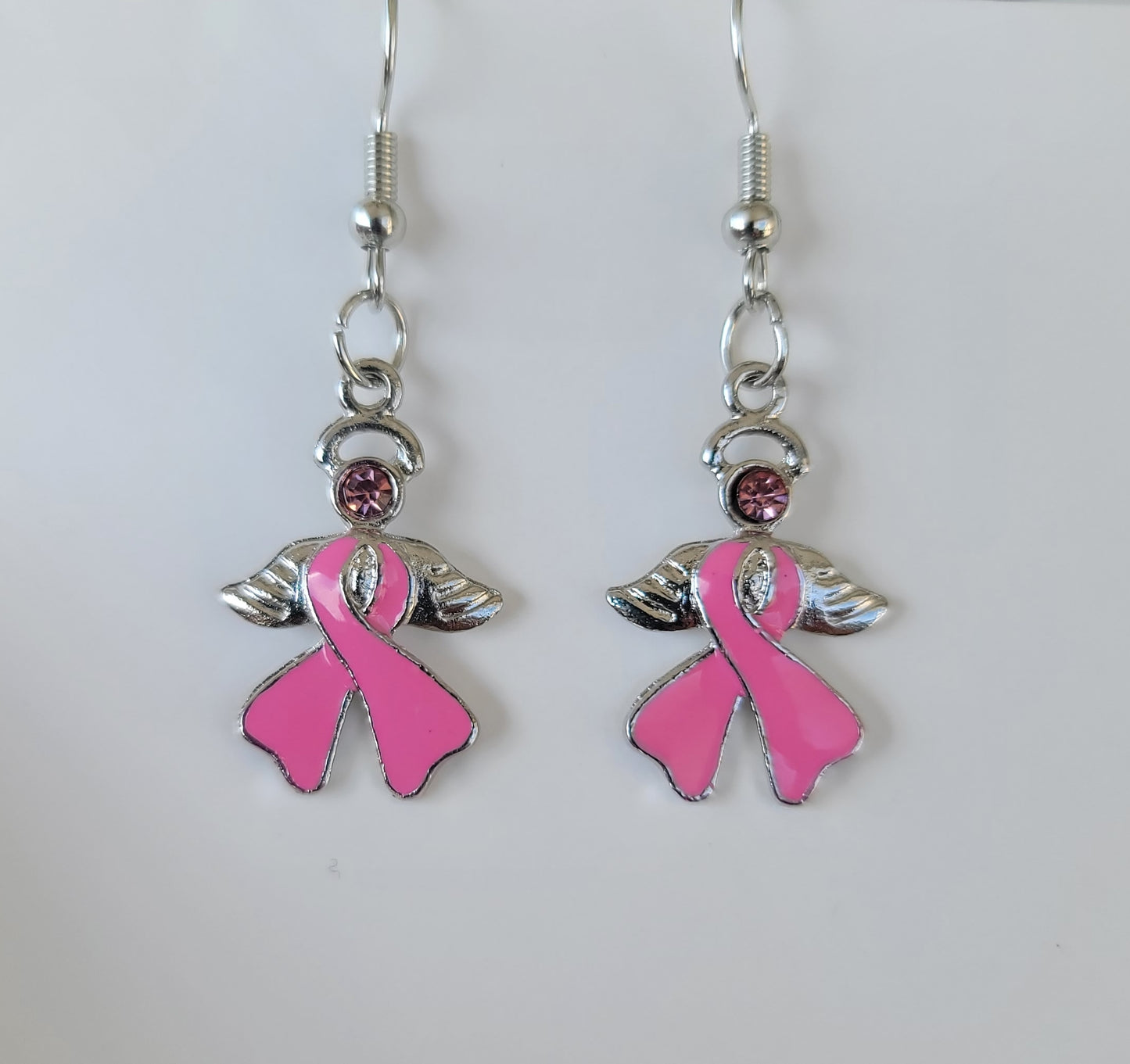 Small pink ribbon angel earrings for breast cancer remembrance with silver finish