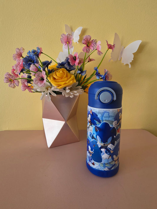 Sonic the Hedgehog tumbler on a table with flowers in the background. 