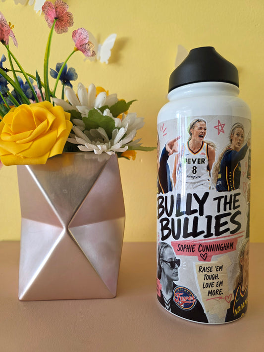 Custom women’s basketball collage water bottle with inspirational quotes displayed beside a geometric vase and yellow rose
