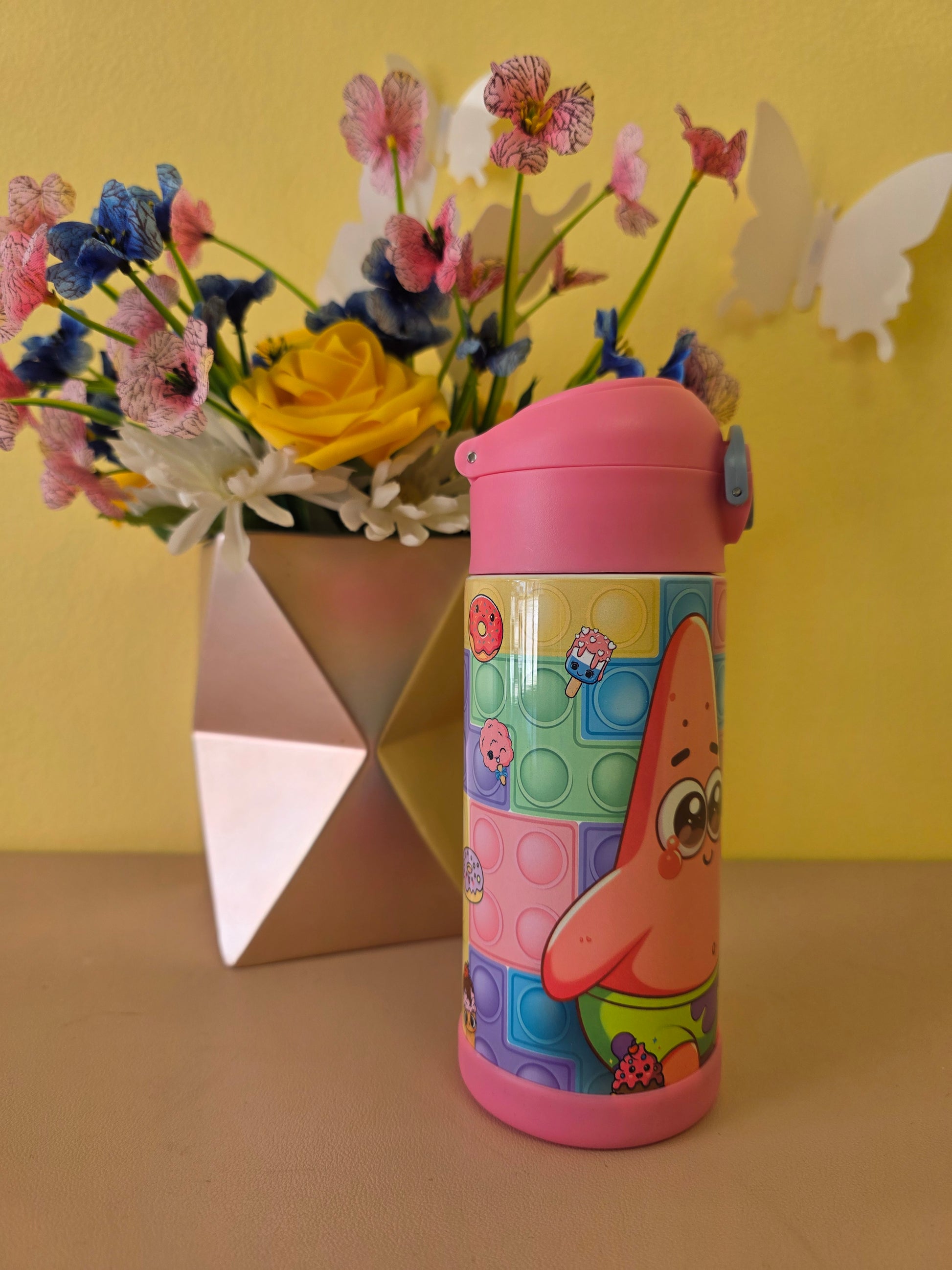 Colorful cylindrical container with a cartoon design on a yellow background