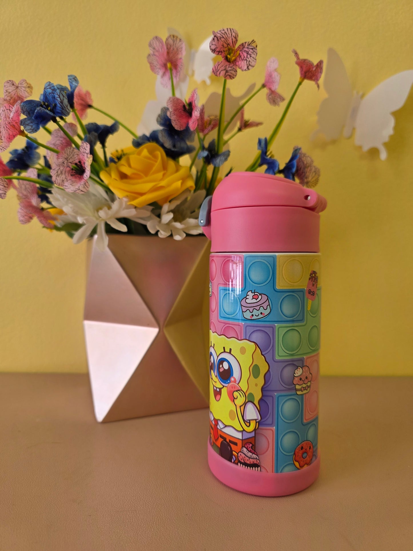 Colorful pop-it fidget toy with cartoon character on a yellow background