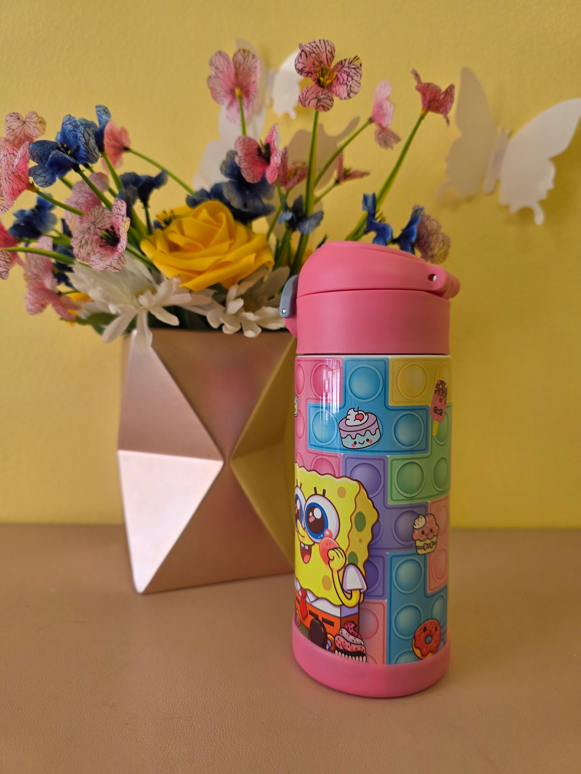 Colorful pop-it fidget toy with cartoon character on a yellow background