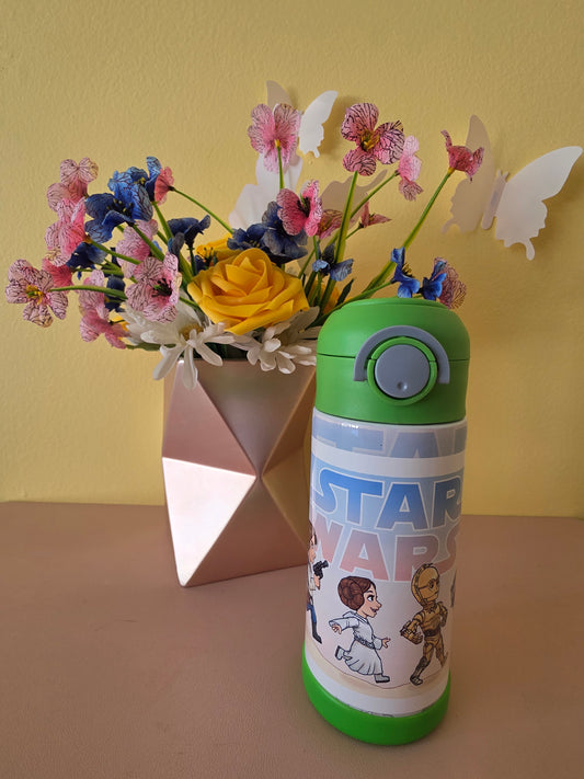 Star Wars kids tumbler on a table with flowers in the background. 