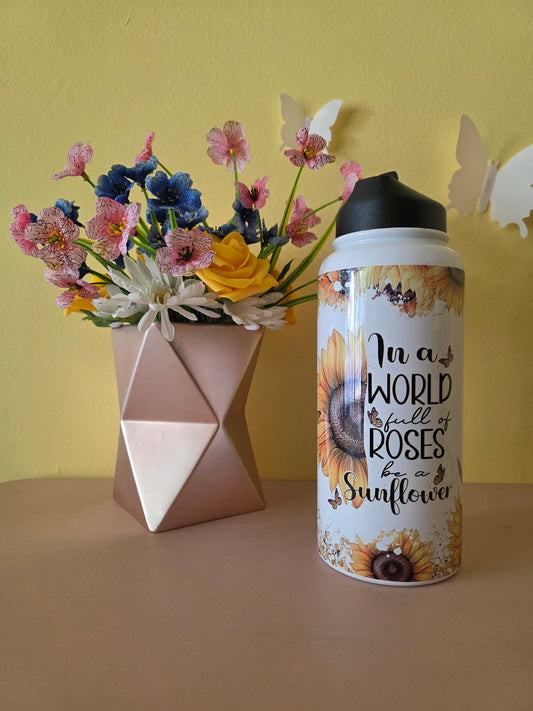 Sunflower themed water bottle tumbler on a table with yellow background