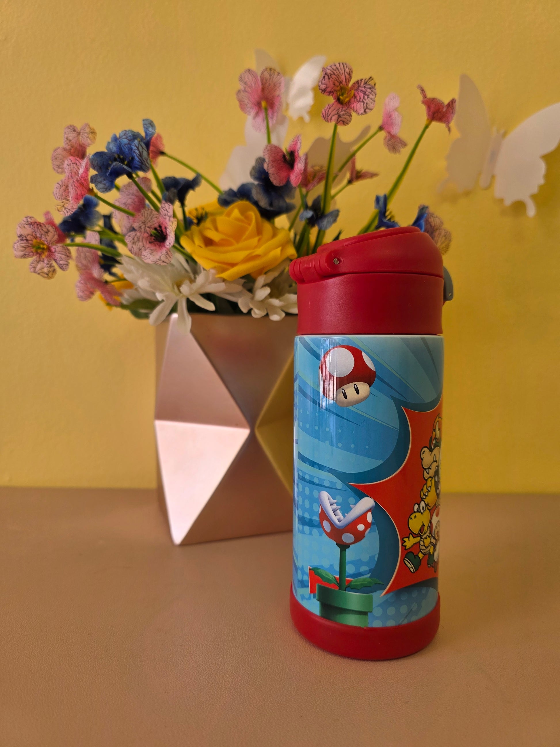 Colorful cylindrical container with cartoon design on a yellow background