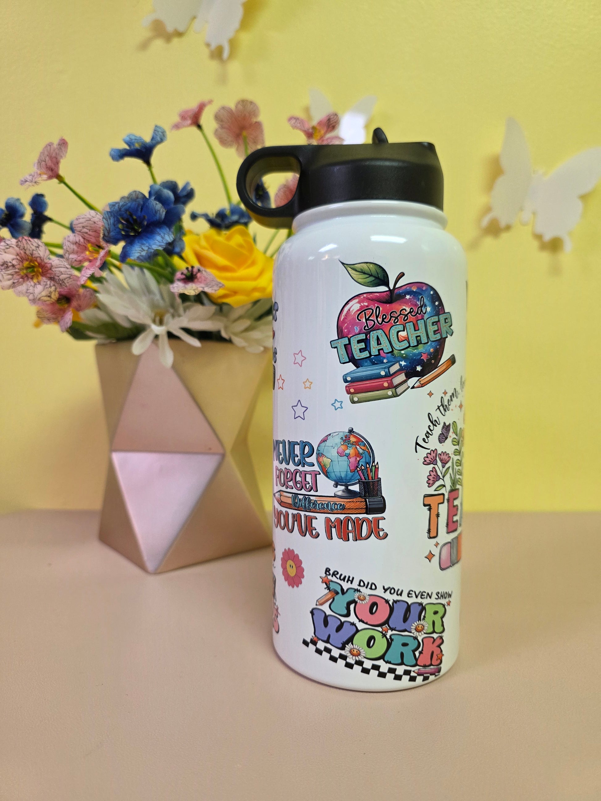 Colorful water bottle with text and graphics on a yellow background with flowers and a box.