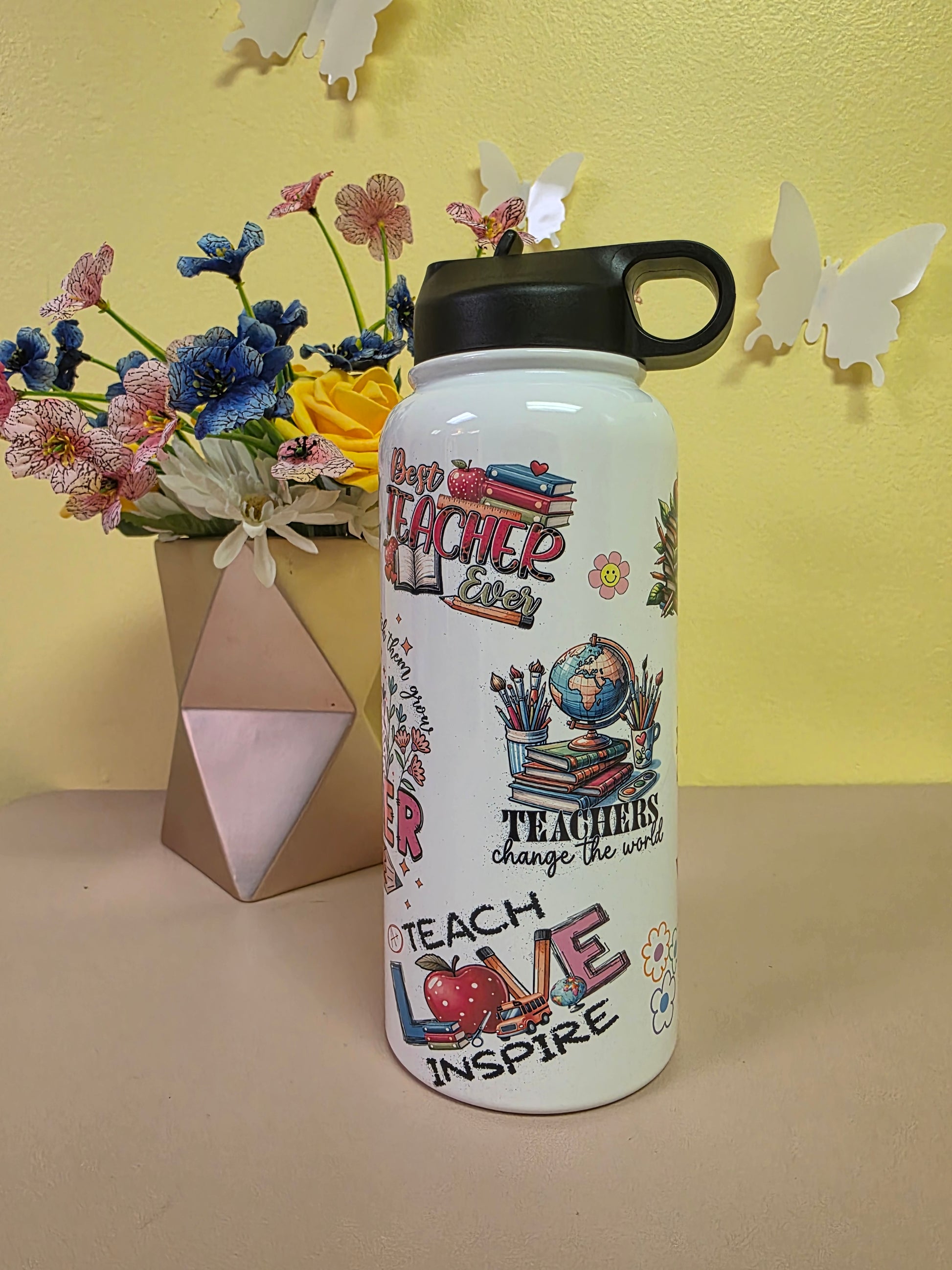 White water bottle with colorful designs and text on a yellow and beige background